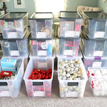 Heavy-duty storage bins stacked neatly in a home garage, protecting seasonal kitchen appliances and holiday supplies