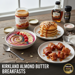 A delicious breakfast spread featuring almond butter pancakes, a vibrant berry smoothie bowl, and bacon-wrapped apple slices with Kirkland almond butter.